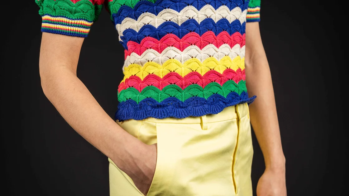 Woman wearing a colorful knitted top and yellow pants. © Sport Kessler GmbH