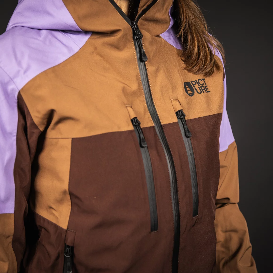 Close-up of a woman's Picture Organic Clothing jacket in brown and purple. © Sport Kessler GmbH