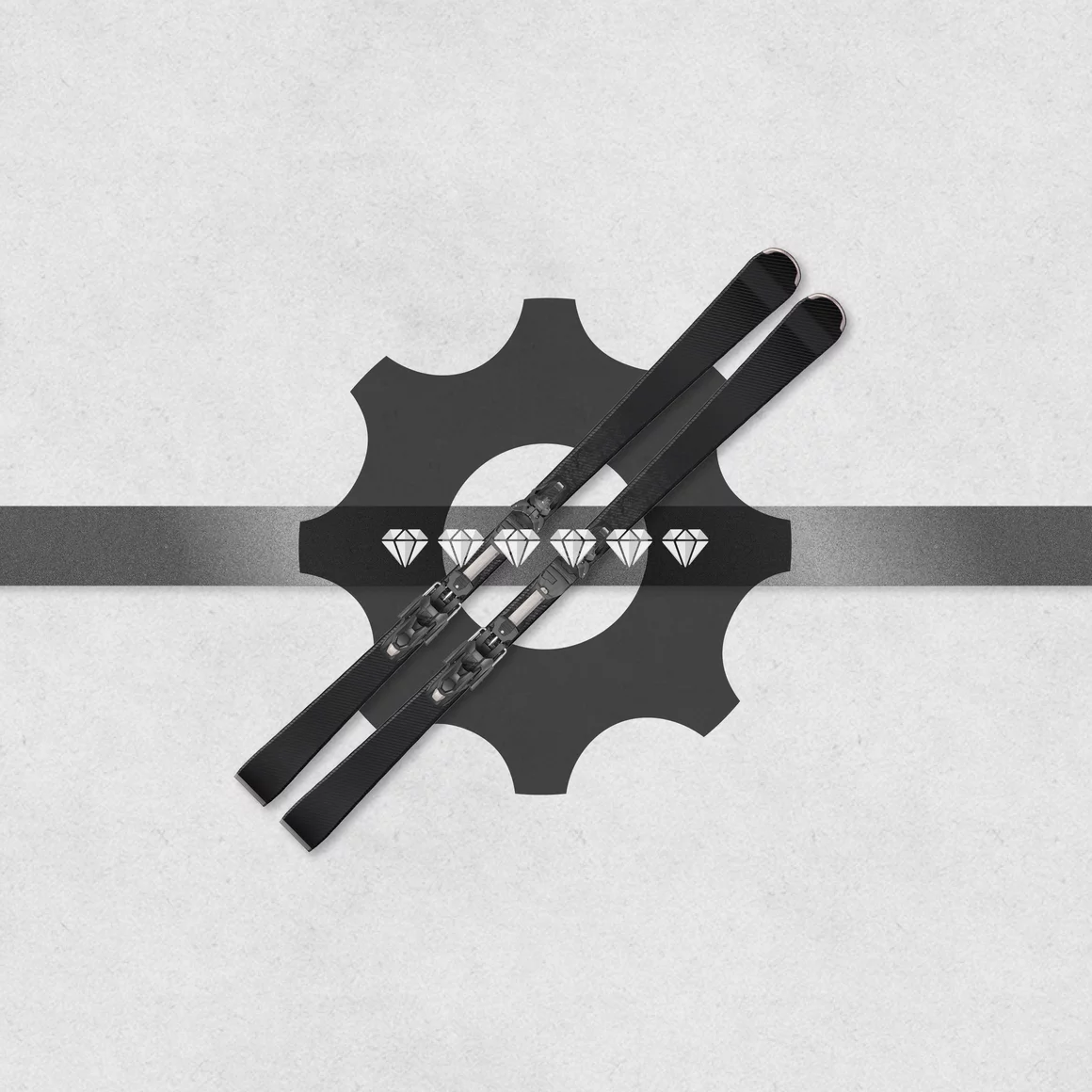Pair of black skis over a gear graphic. © Sport Kessler GmbH