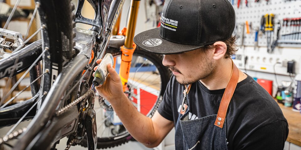 Mechanic lubricating a mountain bike chain. &copy; Sport Kessler GmbH